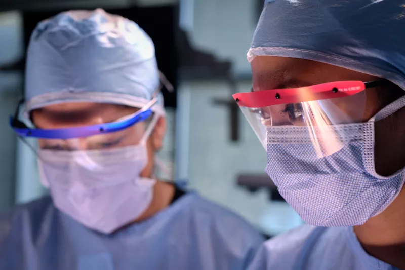 A scene of two surgeons in the surgery room