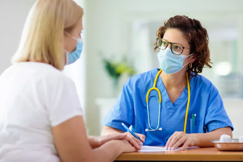 A woman visiting her health care provider. 